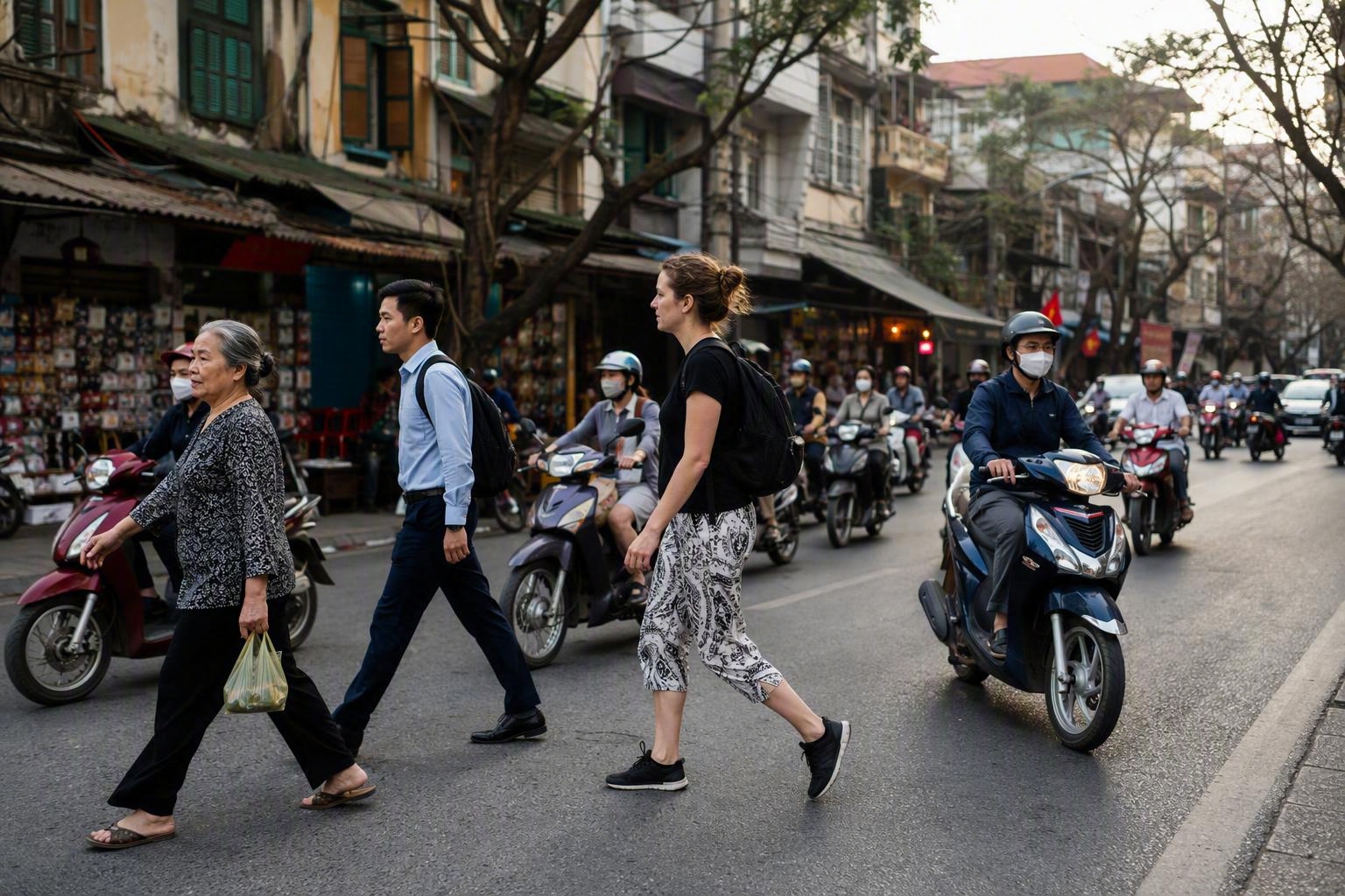 Locals and travellers crossing a Hanoi street together