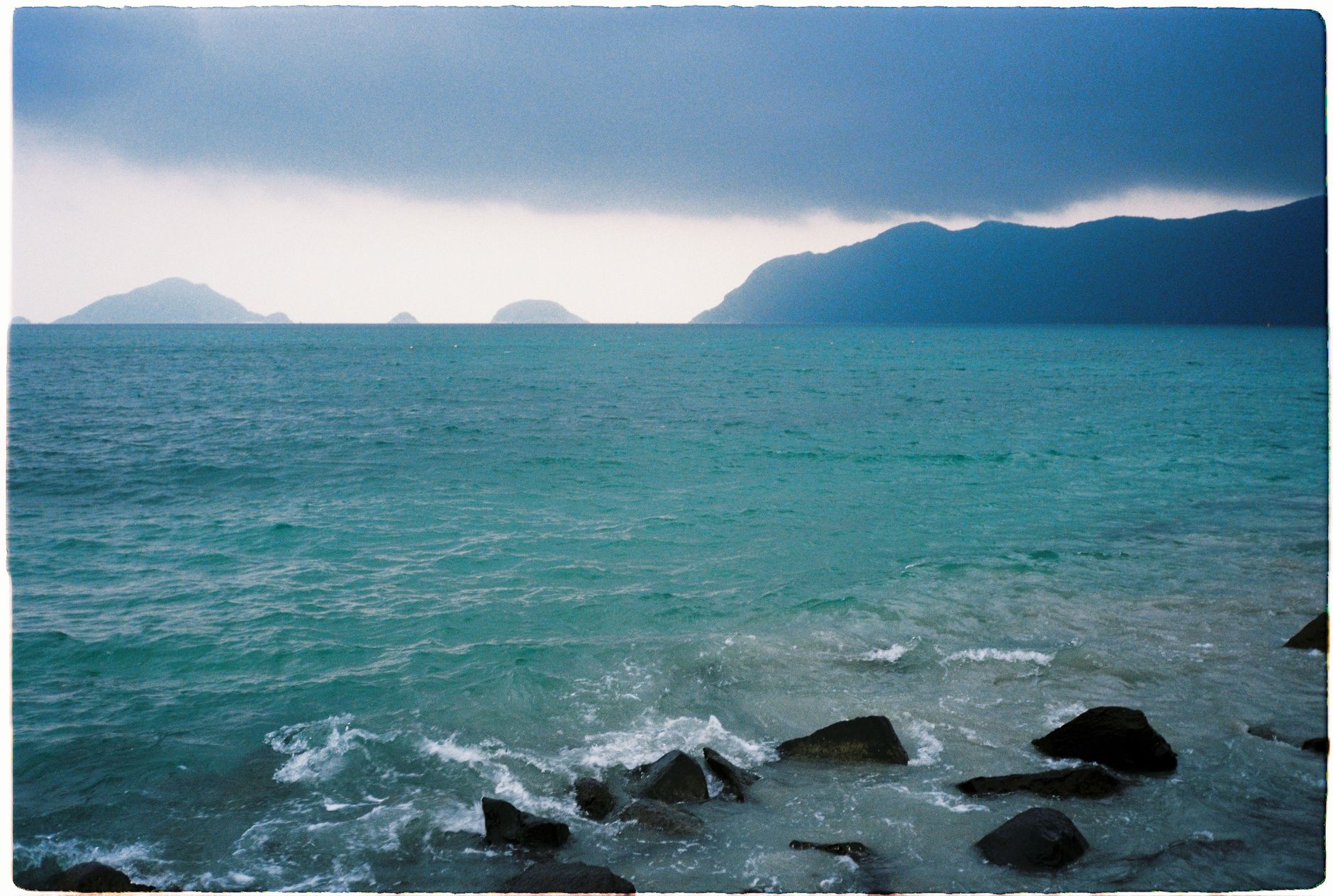 Further reading — Dramatic seascape with rocky shore and distant islands in Vietnam. (photo: sephylmism)