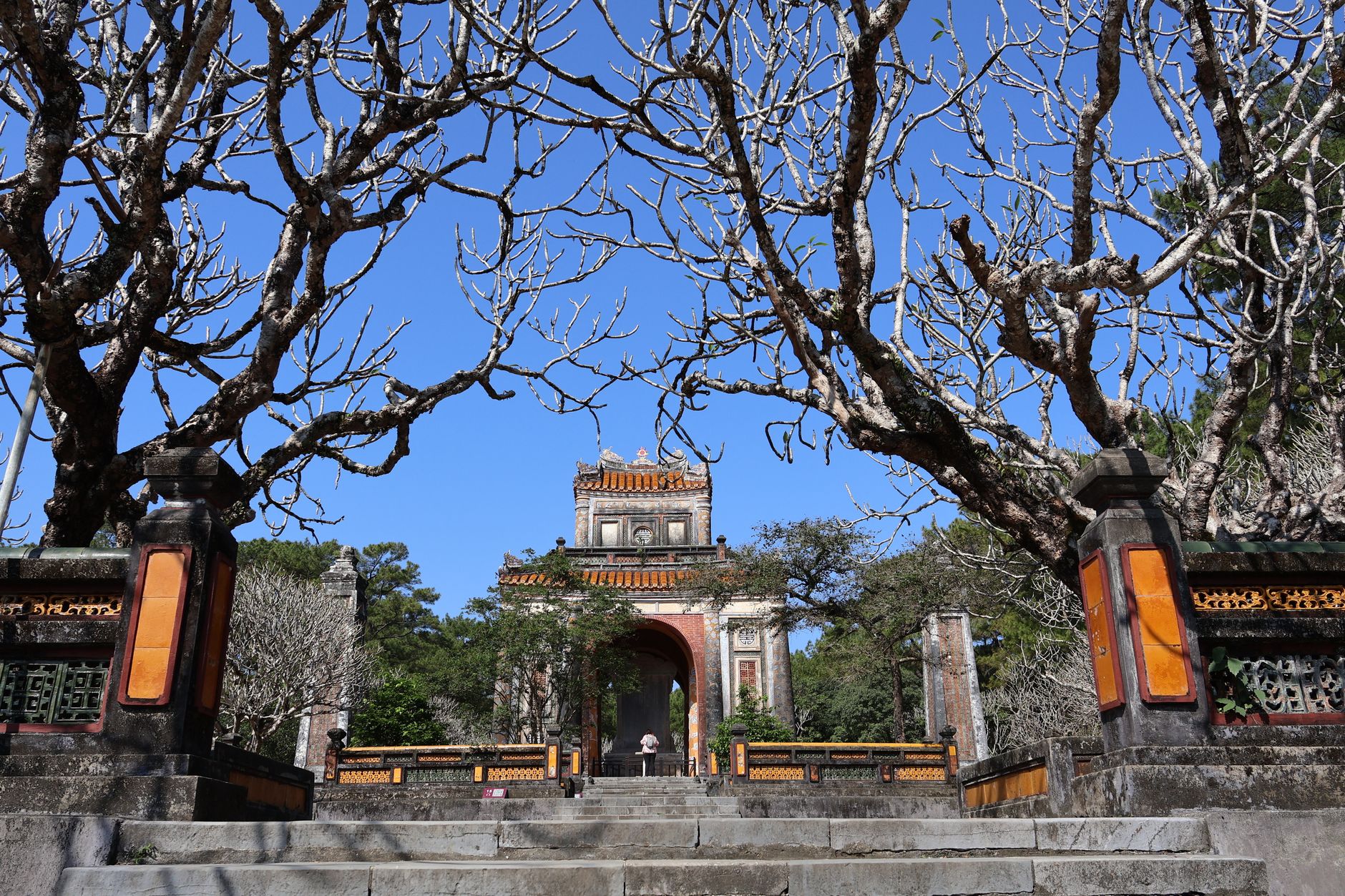 Planning notes — The majestic entrance of Minh Mang Tomb framed by bare trees in Hue, Vietnam. (photo: Minh Lê)