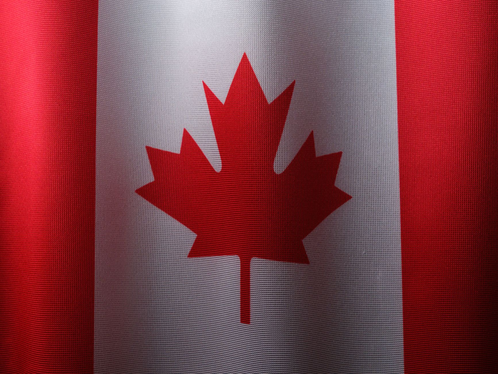 Nearby Ideas — Close-up view of the Canadian flag with its iconic red maple leaf. (photo: Engin Akyurt)