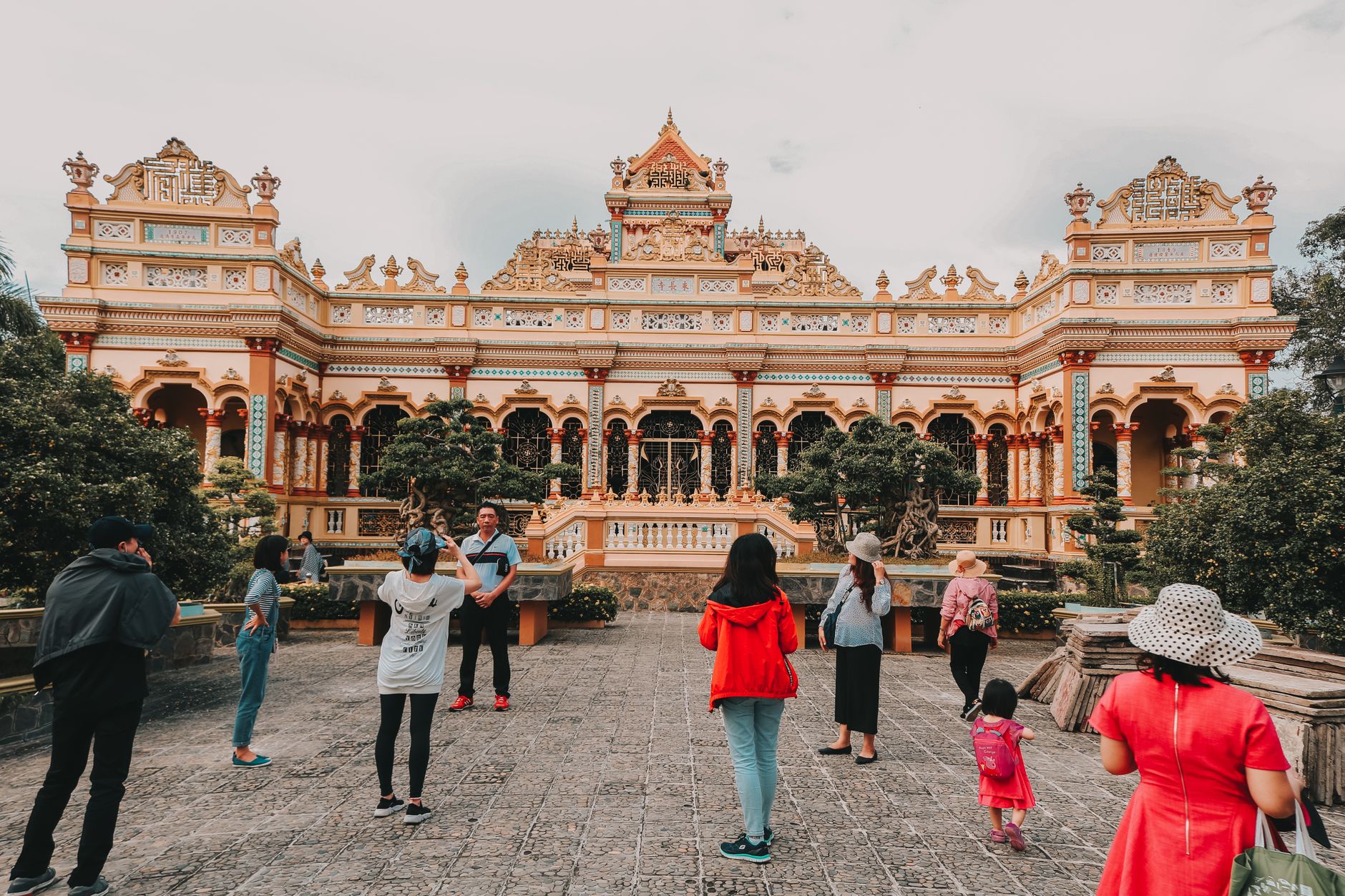 Conclusion — Visitors exploring the historic Vinh Trang Temple, a famous landmark in Vietnam. (photo: Loifotos)