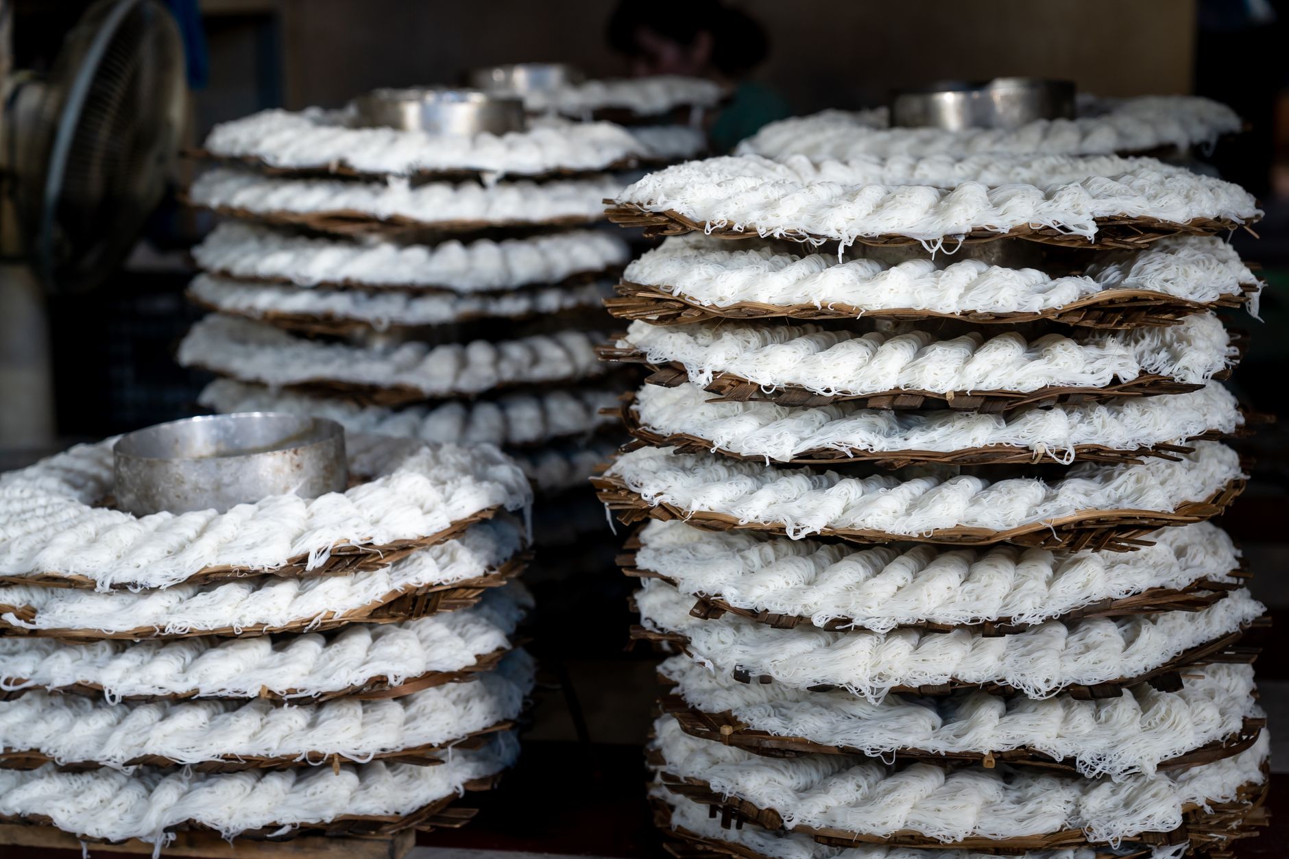 What to Expect on the Ground — Close-up of layers of banh hoi noodles drying on bamboo trays in Vietnam. (photo: Quang Nguyen Vinh)
