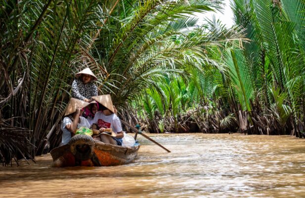 Explore the vibrant scenery on a traditional boat ride through the Mekong Delta's palm-lined waterways. — photo: Tomáš Malík