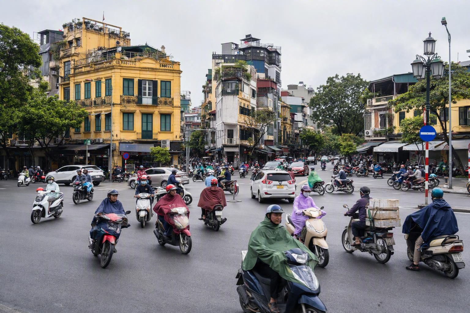 Hanoi street crossing at a busy intersection full of motorbikes