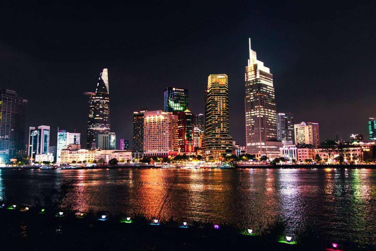Vibrant nighttime view of Ho Chi Minh City's skyline reflecting on the river. — photo: Tường Chopper