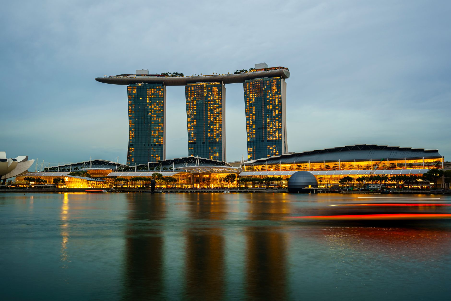 Planning Notes — Marina Bay Sands illuminated at sunset in Singapore, reflecting on calm waters. (photo: Cyrill)