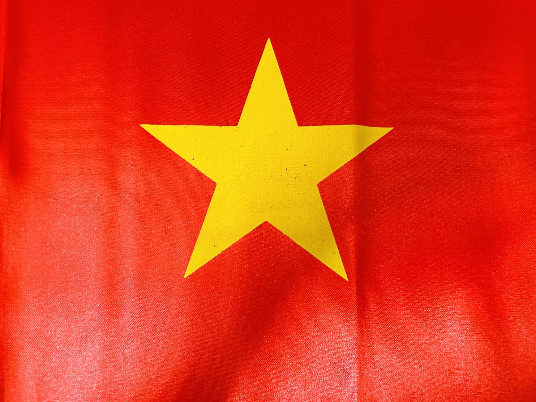 Nearby Ideas — Close-up of Vietnam's national flag featuring a yellow star on a red background. (photo: Jonny Phan)