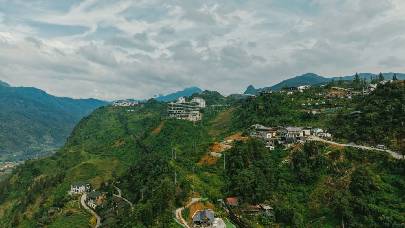 Stunning aerial landscape of green hills and modern buildings in Sapa, Vietnam. — photo: HONG SON