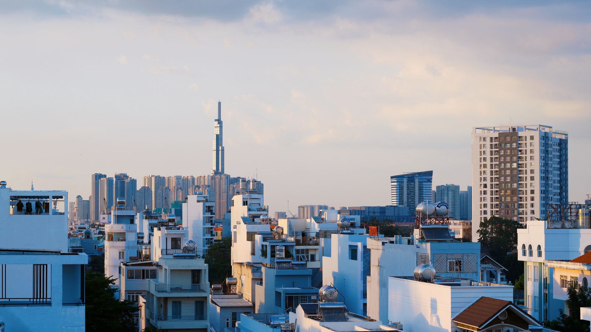 Nearby Ideas β A scenic aerial view of a city skyline with modern skyscrapers under a blue sky. (photo: Bich Tran)