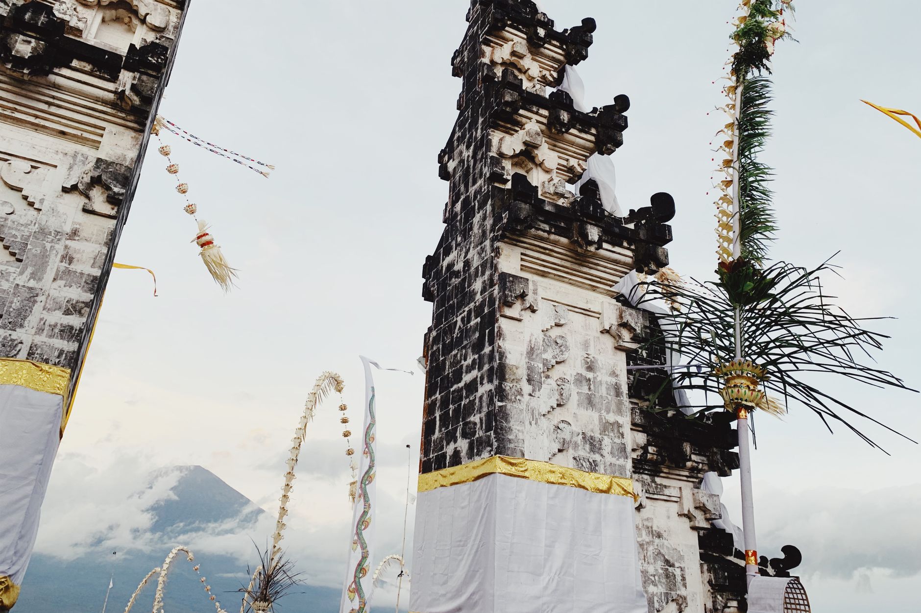 What to Expect on the Ground β View of traditional Balinese temple gates with scenic Mount Agung in the distanc (photo: SHVETS production)
