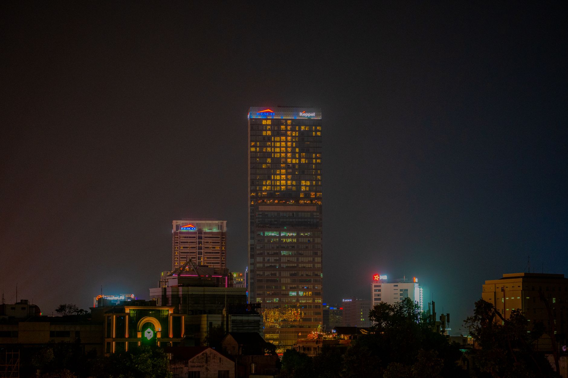 Nearby Ideas — Illuminated skyscrapers in the night skyline of Ho Chi Minh City, showcasing urb (photo: Vuong)