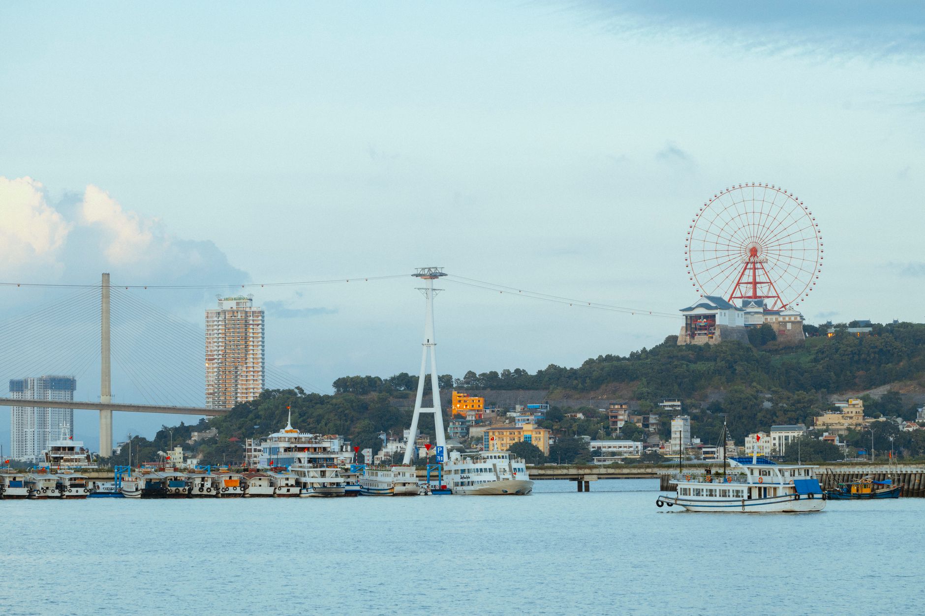 Conclusion — Panoramic view of Ha Long Bay featuring a Ferris wheel, bridge, and ships. (photo: HONG SON)
