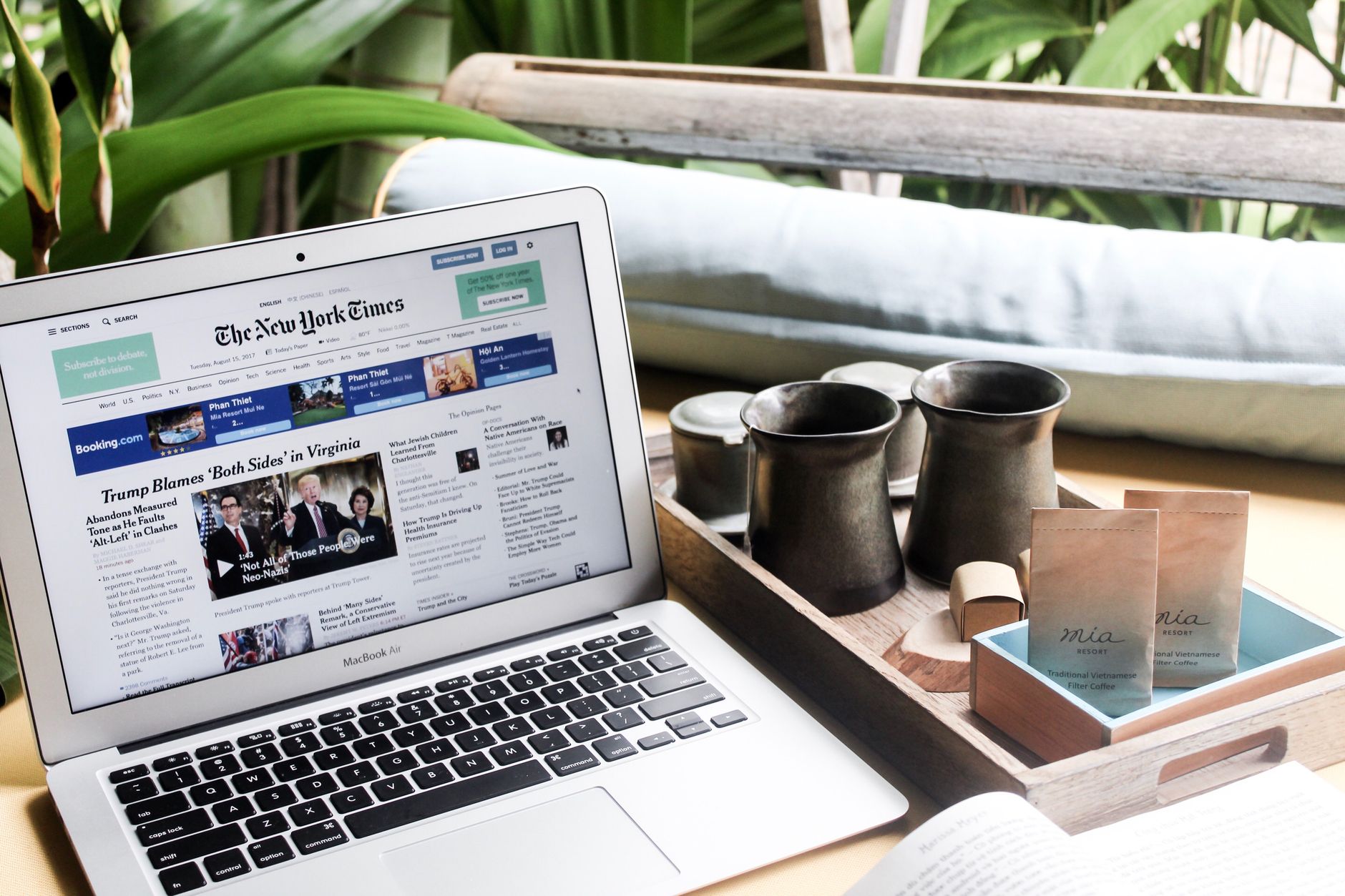 What to Expect on the Ground β High angle of modern laptop with news on screen placed on table next to tin cups (photo: Jane T D.)